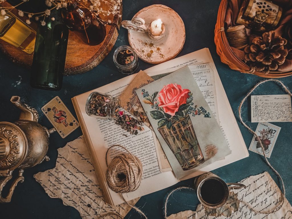 still life with vintage postcards and decoration on a green table